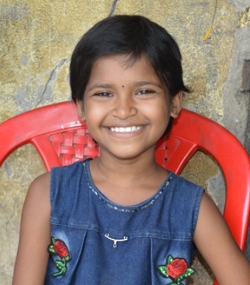smiling girl sitting in red chair