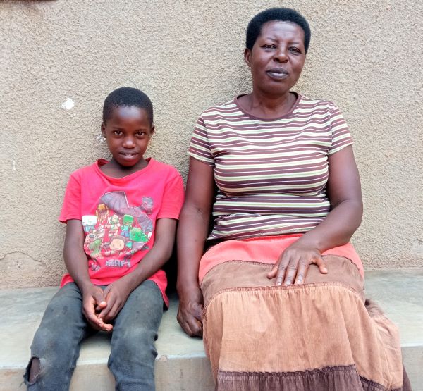 Boy and his mom sitting on a bench in Uganda