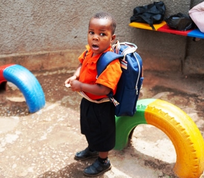 young Ugandan boy standing at playground