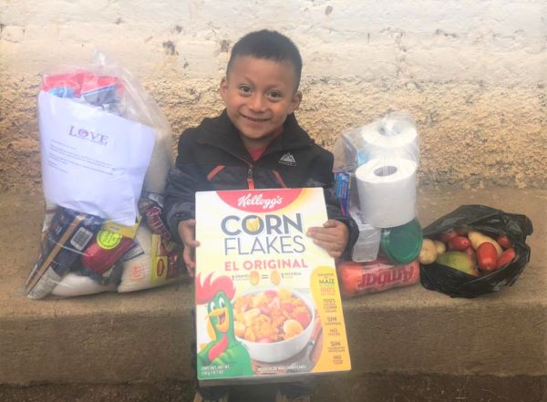 Guatemalan boy holding cereal box