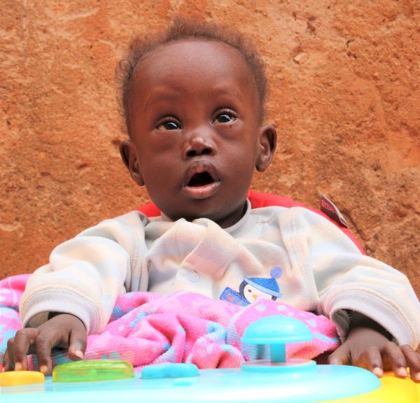 Uganda boy with Down syndrome in walker