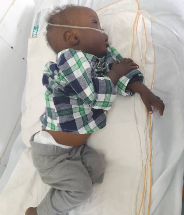 Baby lying in hospital bed
