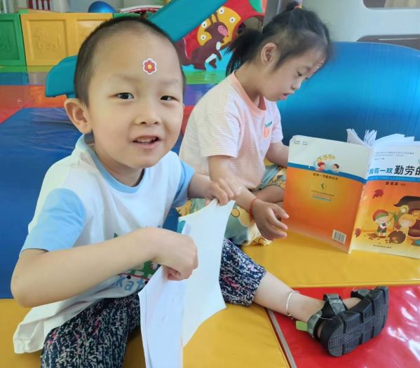 Boy playing with sticker on forehead