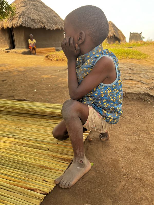 Barefoot boy in Uganda