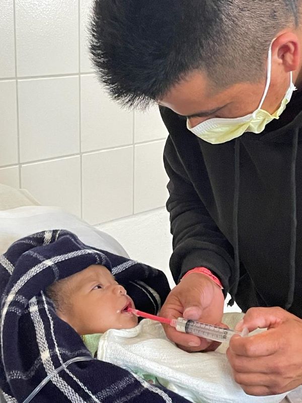 Father feeds cleft-affected daughter with syringe