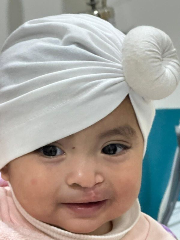 Baby in white head wrap