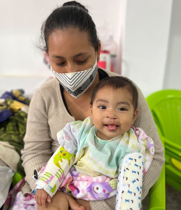 Smiling girl and her mother after cleft surgery