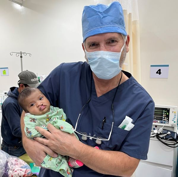 Doctor holding baby before cleft surgery