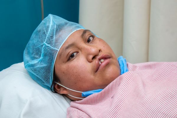 Teenage girl with cleft lip preparing for surgery