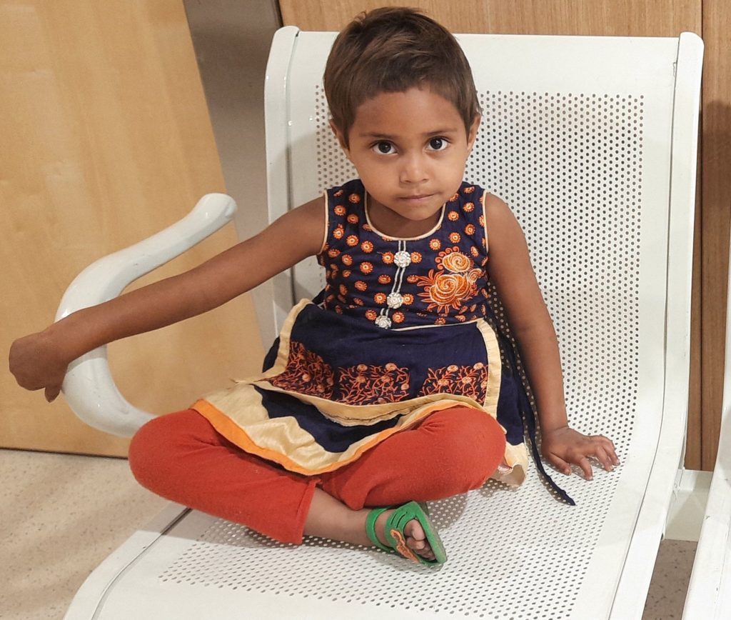 Indian girl sitting in hospital chair