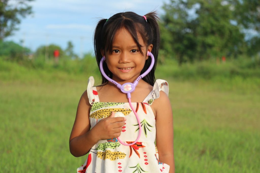 Cambodian girl with a toy stethoscope