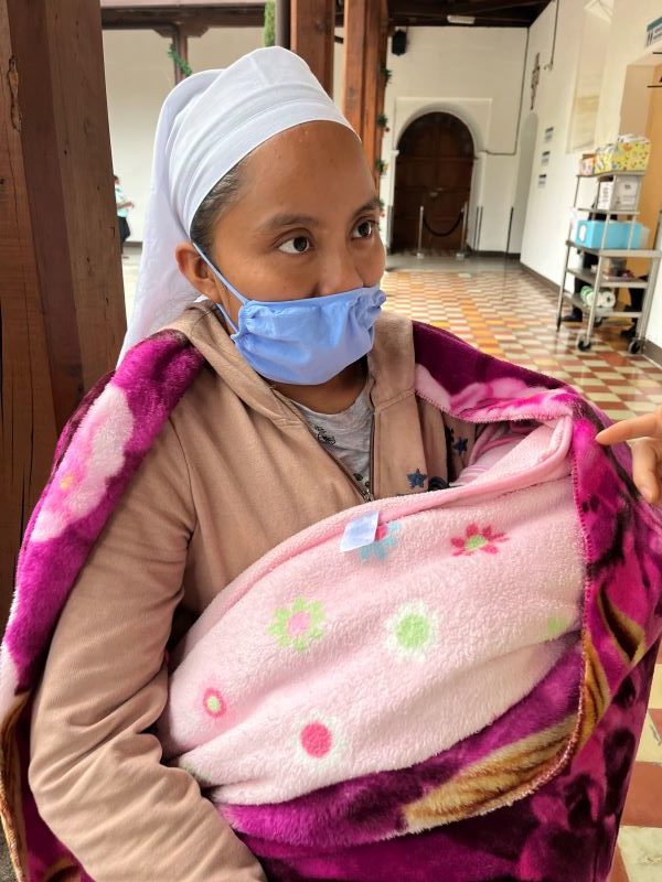Mother brings baby to the Love Without Boundaries Guatemala Cleft Trip