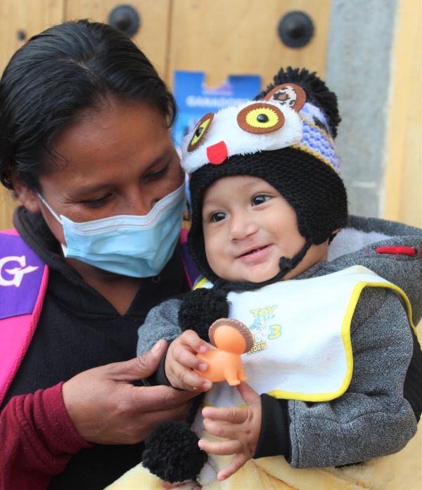 Mother son in Guatemala holding toy