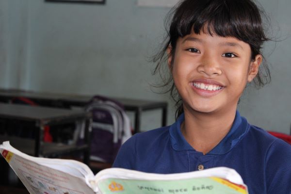 Cambodian girl reading at school