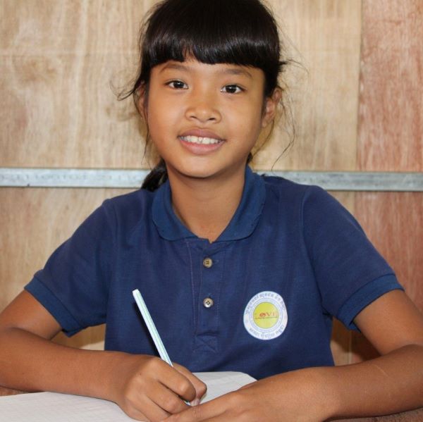 Cambodian girl writing at school