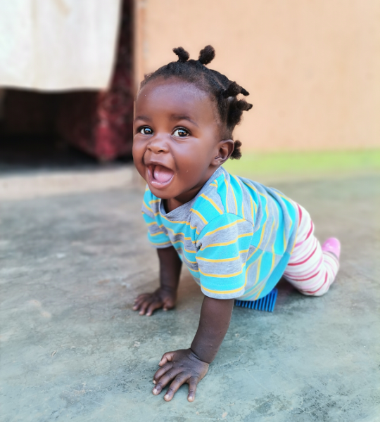 young Ugandan girl crawling