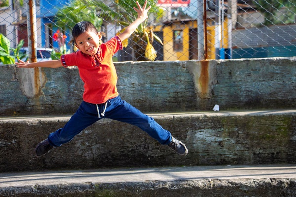 young boy jumping for joy in Guatemala