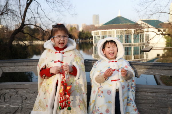 Children celebrating the Year of the Rabbit by a lake