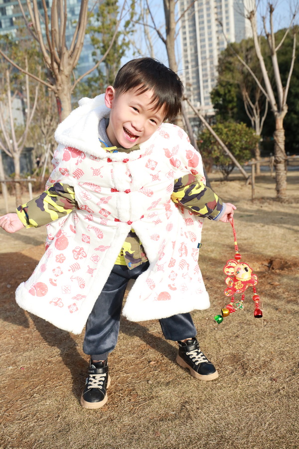 Little boy jumping in Year of the Rabbit clothing