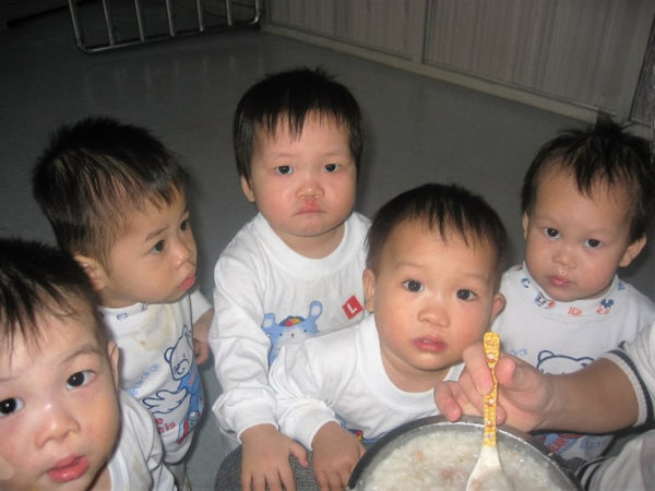 Five children waiting to eat in an orphanage