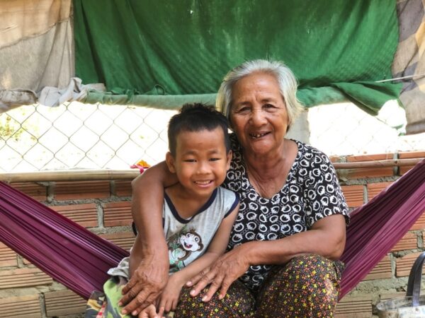 Grandma with arm around smiling boy