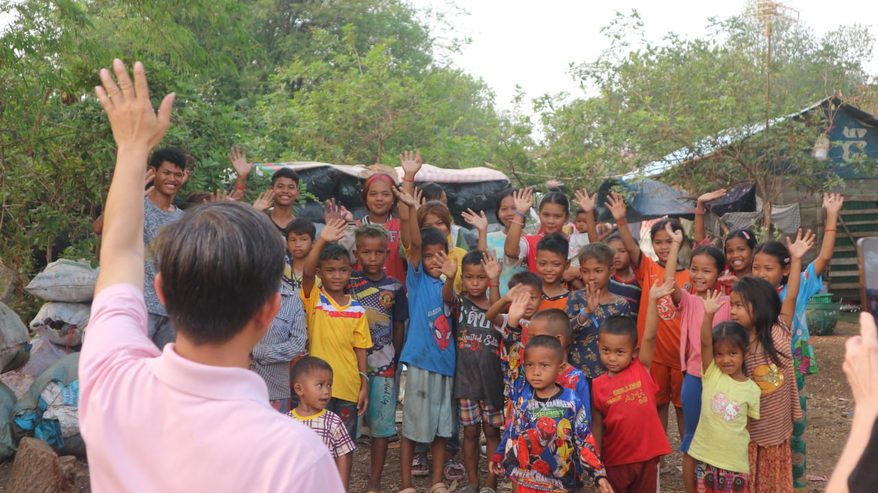 Group of kids raising hands in Cambodia