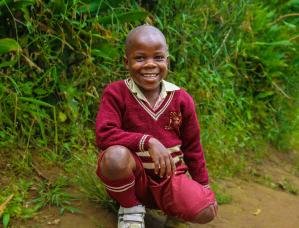 Ugandan boy in red school unifiorm