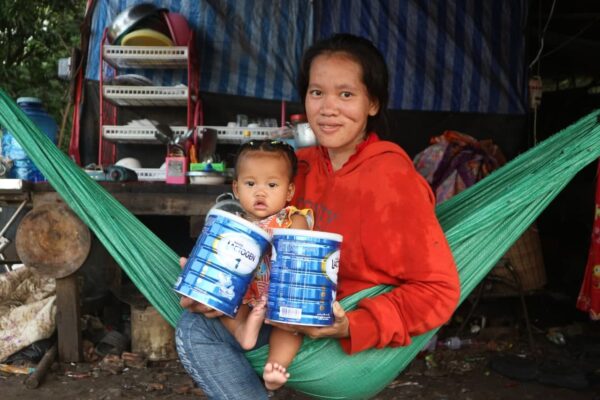 Mom and child with formula in green hammock
