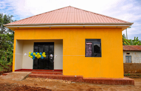 Brand new orange home with balloons across the front door
