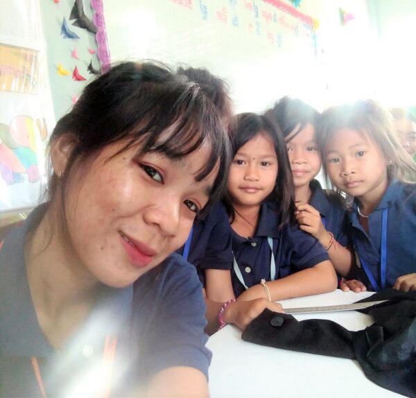 Cambodian teacher with her students