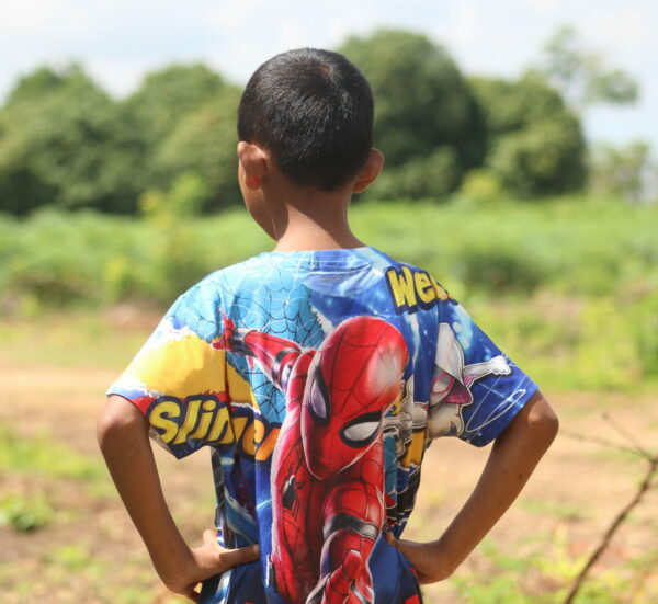 Boy in Spiderman shirt with hands on hips