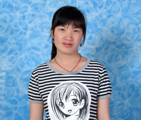 Girl wearing black and white striped shirt standing in front of a blue background