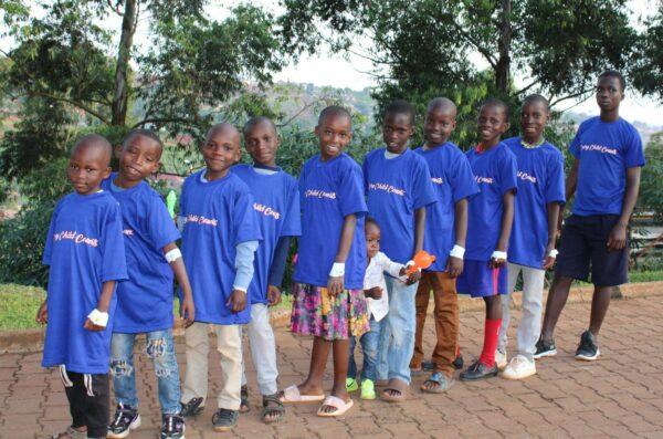 11 children in Uganda waiting for hernia surgeries wearing blue shirts