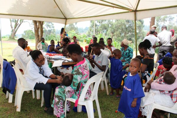 Children getting assessed in a white tent at a hernia medical mission in Uganda