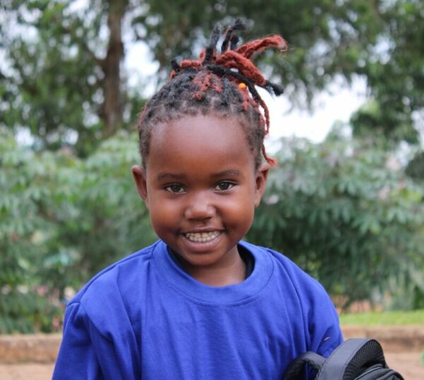 Smiling girl wearing a blue shirt in Uganda