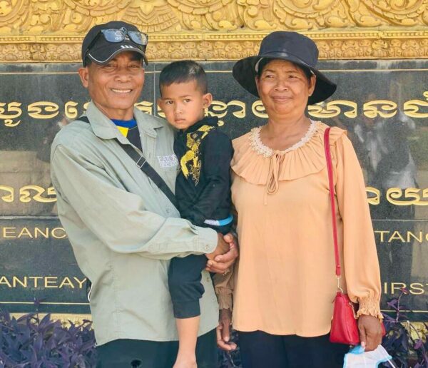 Boy and his new parents after adoption ceremony in Cambodia