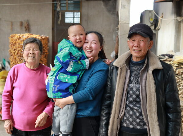Chinese family with a little boy smiling outside
