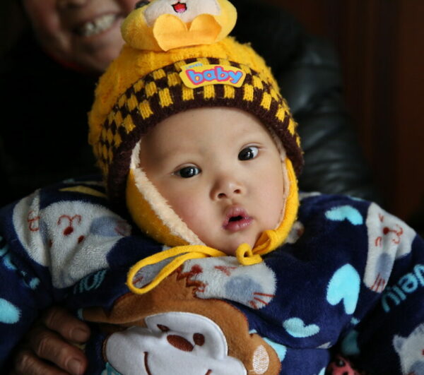 Baby in a bright yellow winter hat