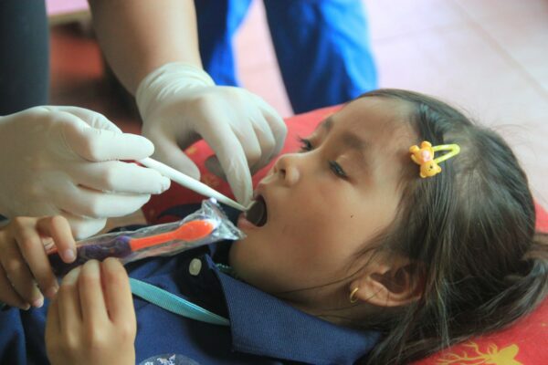 Little girl having a dental exam in Cambodia