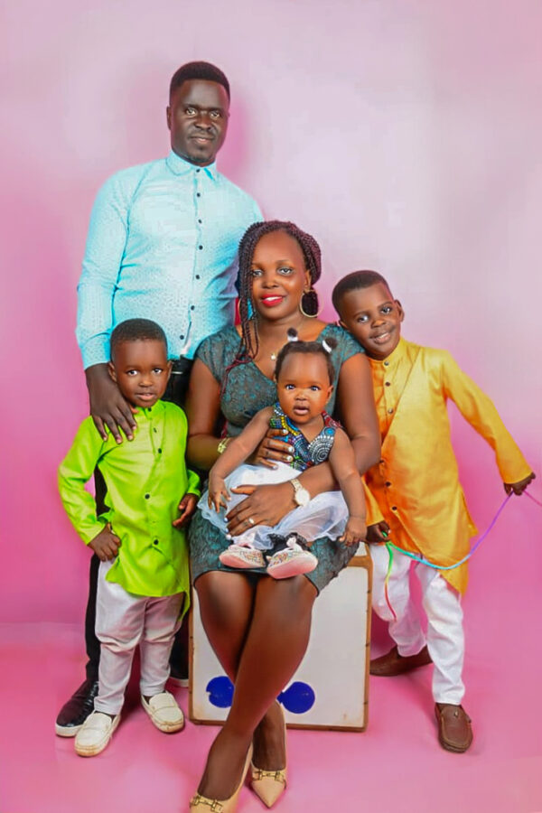Uganda family of mom, dad, and three children in a colorful family portrait