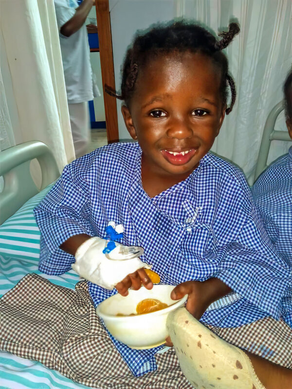 Little girl in hospital bed following heart surgery