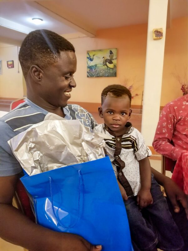 Father and son in hospital holding a blue gift bag