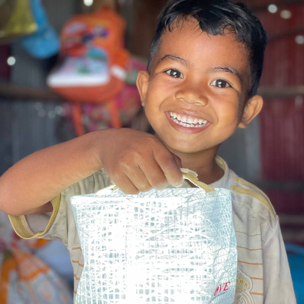 young boy with solar lamp