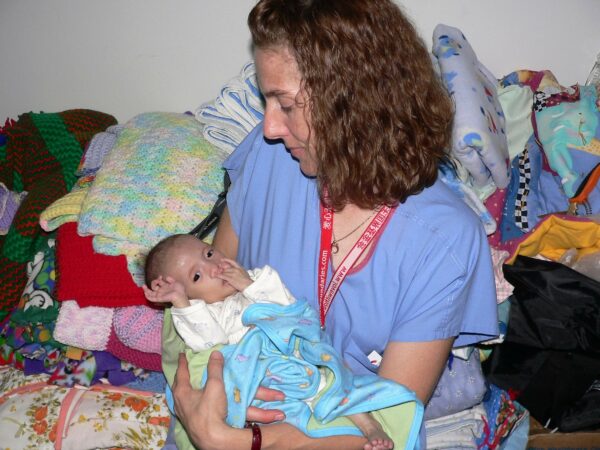 Woman holding baby boy during a cleft surgery mission trip