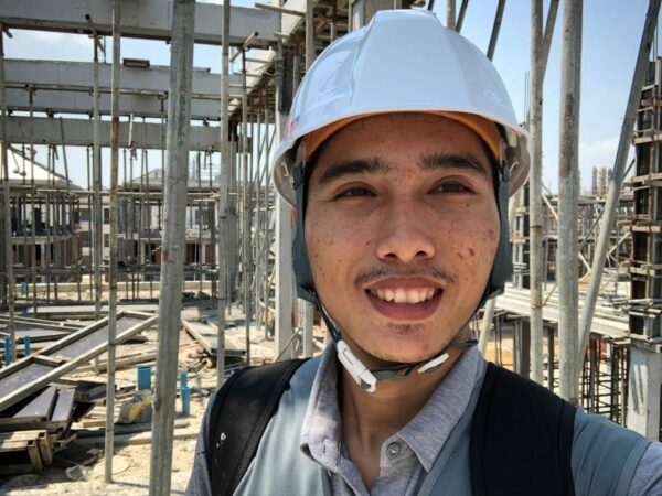Young man at a construction site wearing a helmet