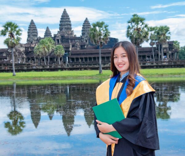 Young female graduate standing in front of Angkor Was