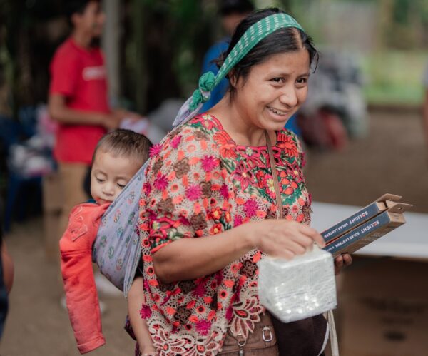 Guatemalan Mother and child on her back with solar light