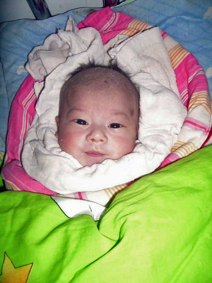 Baby in an orphanage bundled in blankets