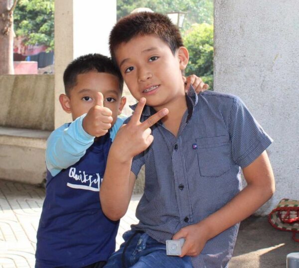 Two boys using sign language
