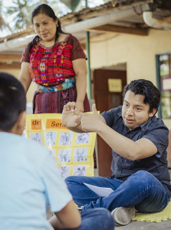 Guatemalan woman and man teaching sign language